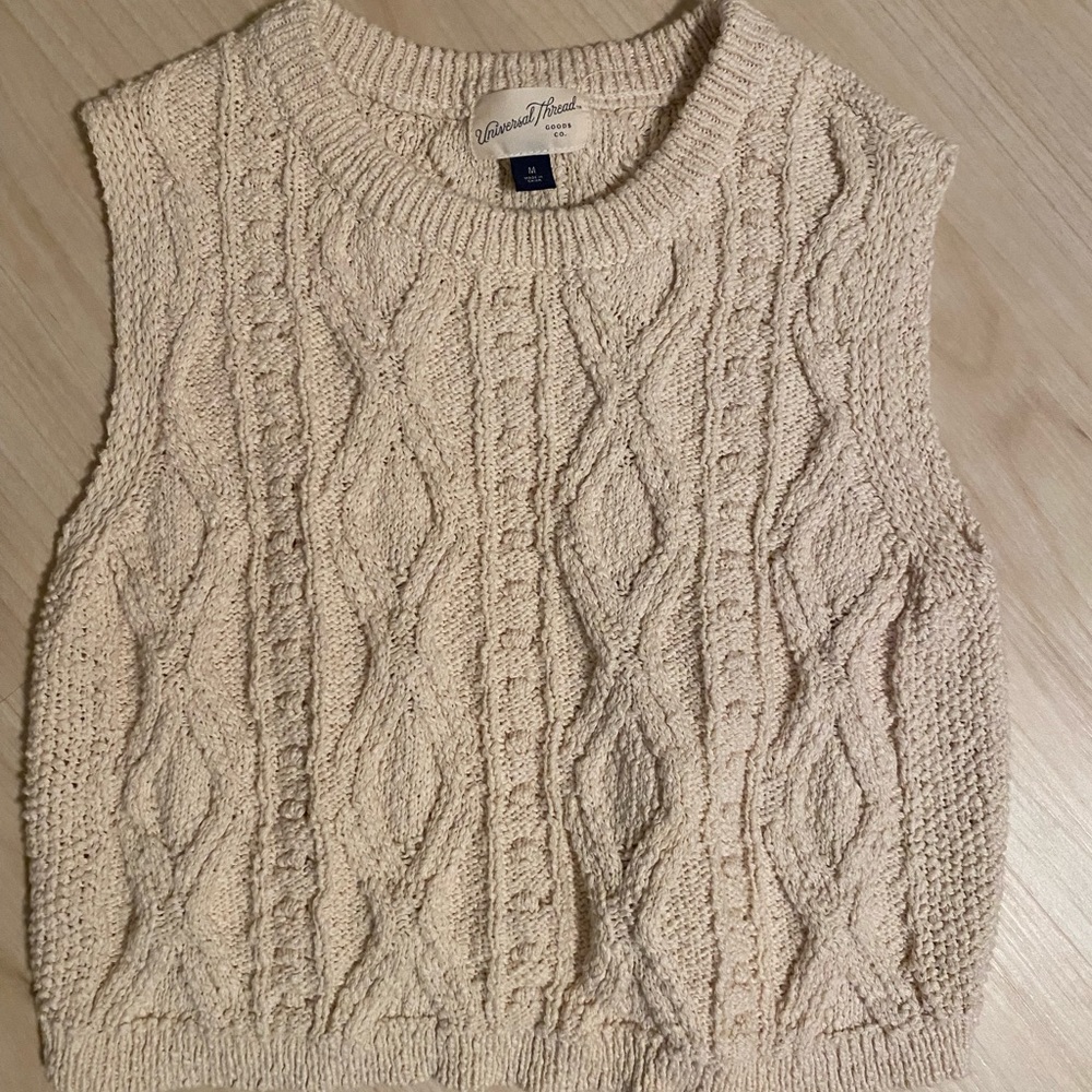 Sweater. Sleeveless. Neutral.